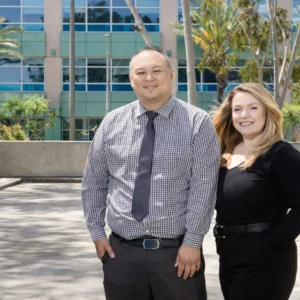 Smiling duo against modern architecture